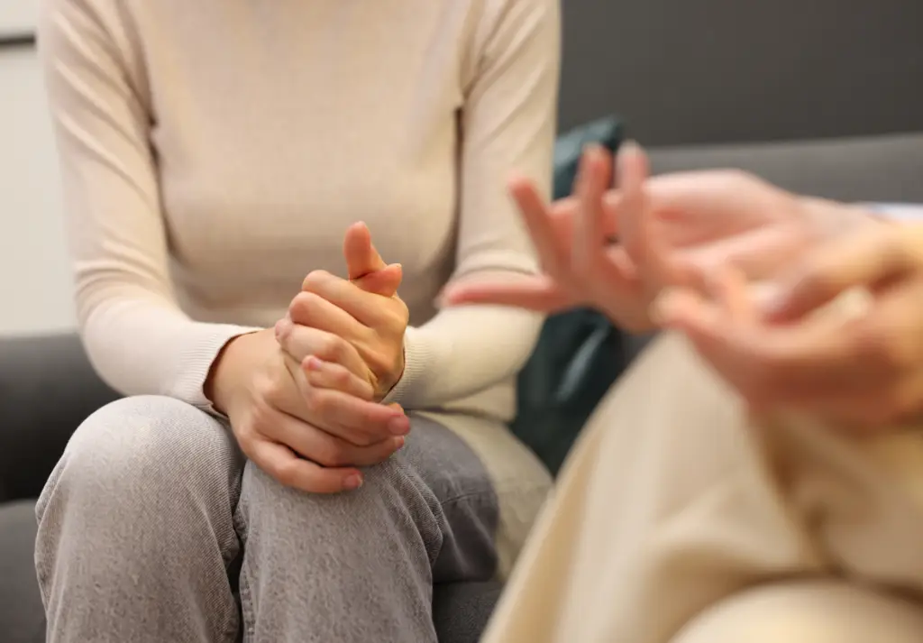 Close-up of hands during a therapy session symbolizing support and guidance through life transitions
