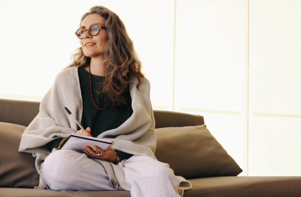 Woman journaling in a peaceful home during spring cleaning your mental space