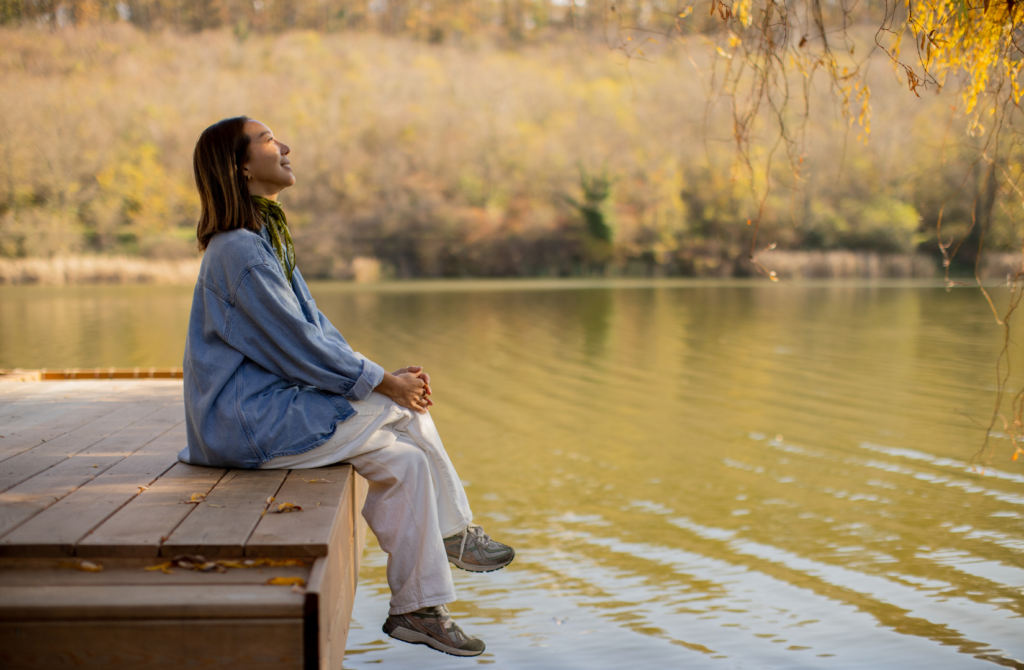 Woman practicing mindfulness outdoors to reduce mental clutter
