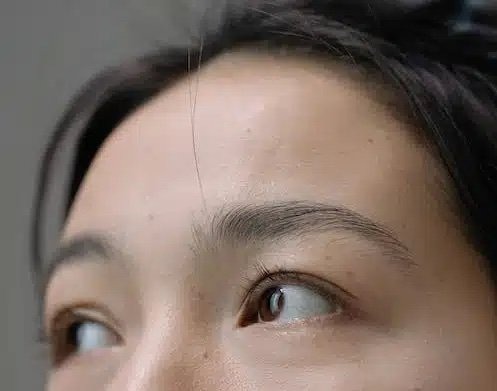 Close up image of woman with brown eyes and dark hair