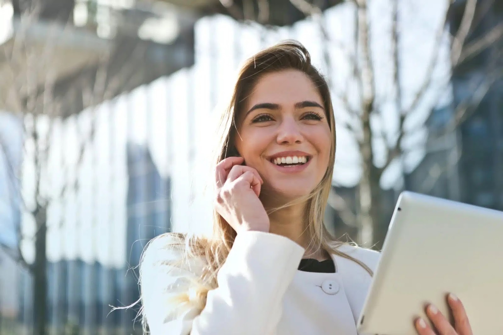 Woman on the phone outside on the computer