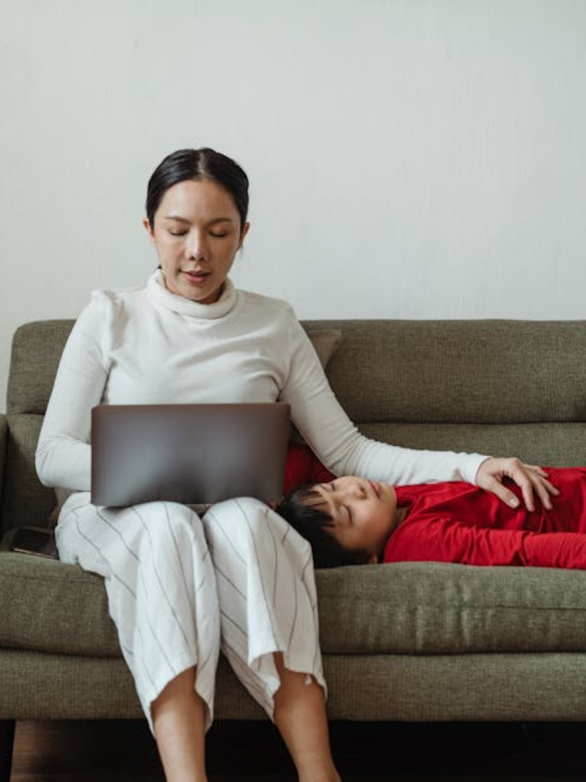 Woman on the couch with her sick child