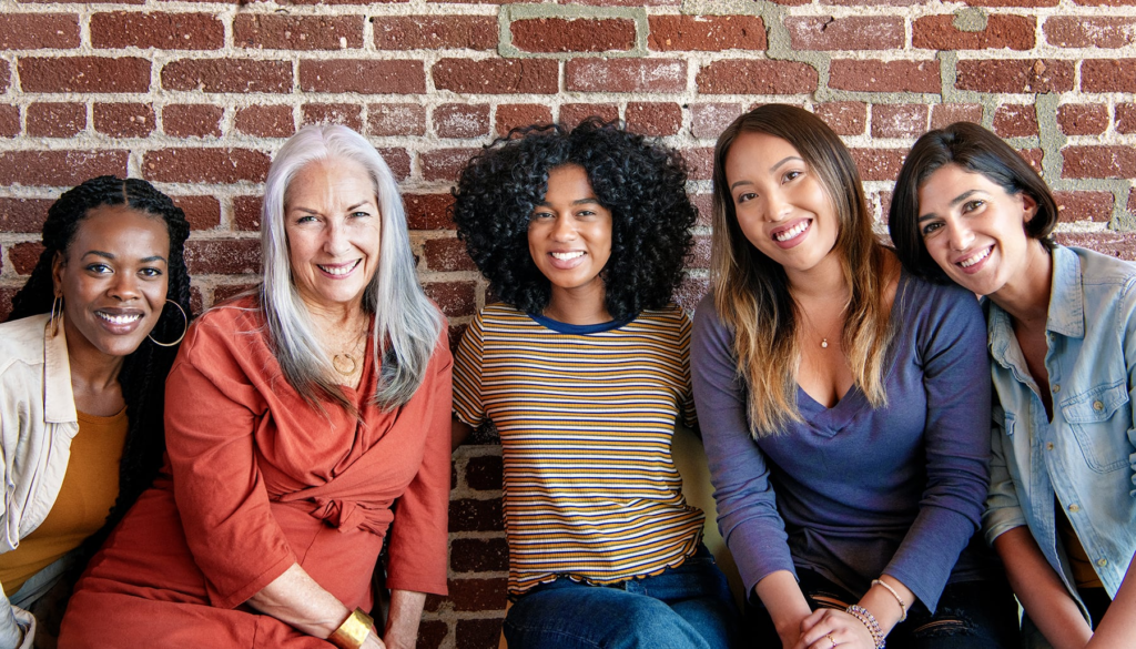 Five women of all ages smiling together