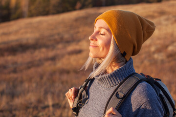 Woman enjoying the sun on her face