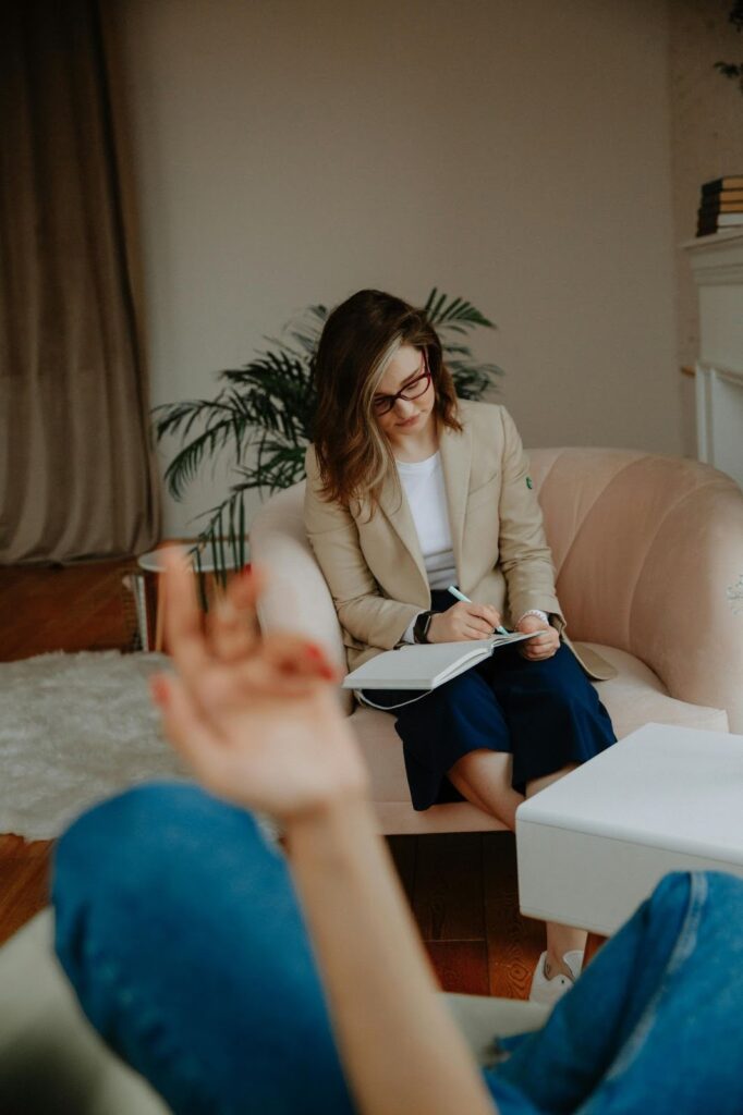 A clean, calming photo of a physical office space featuring comfortable seating and natural light, providing a safe environment as you learn how to choose a mental health professional.