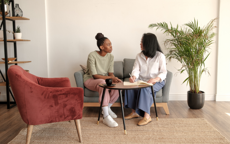 Compassionate therapist listening to client during counseling session about the healing process