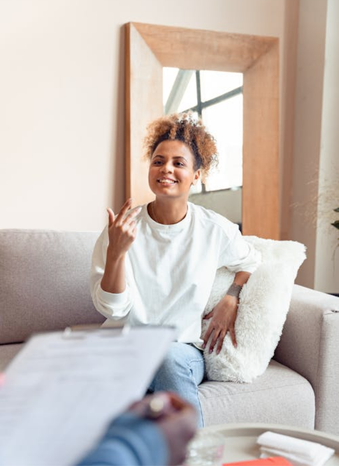 A woman at therapy smiling and talking about her day.