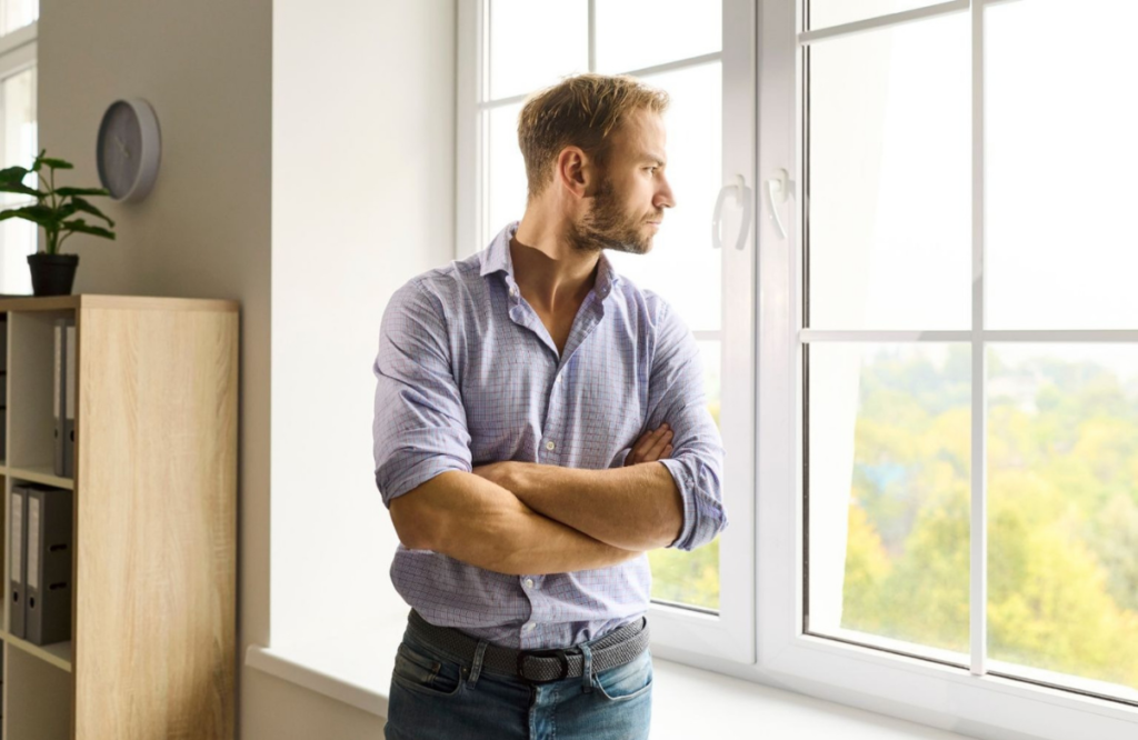 man reflecting on mental health and considering therapy