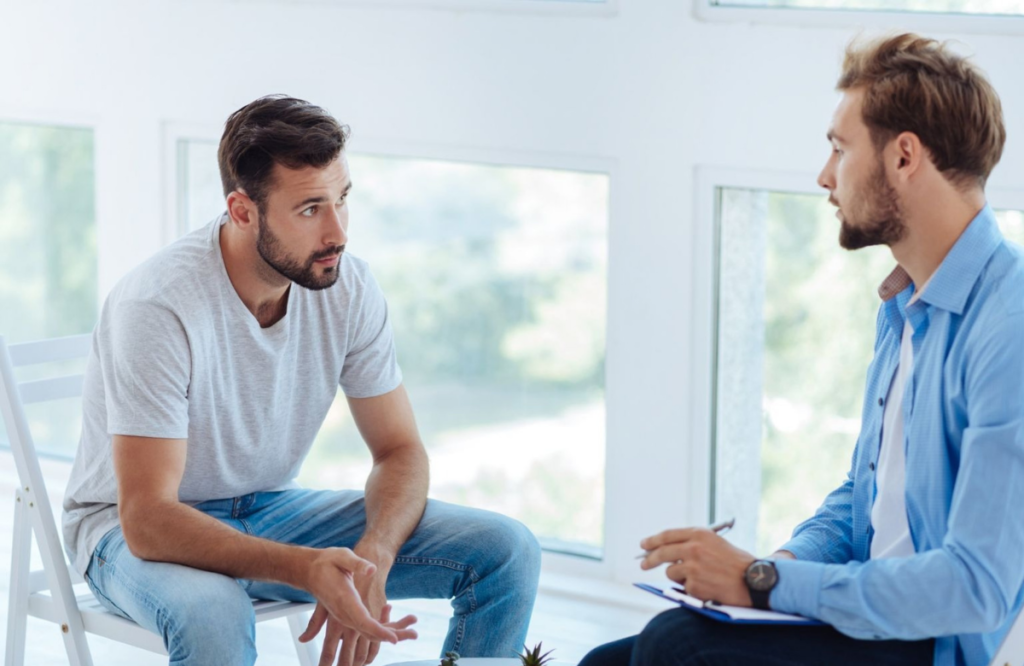 man reflecting on mental health and considering therapy