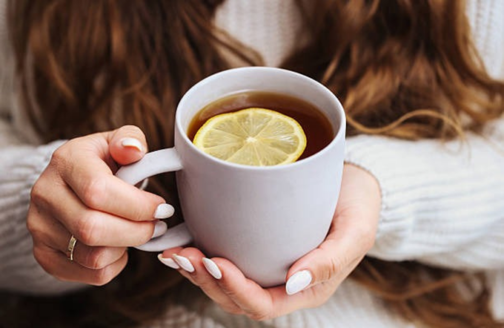 A close-up of hands holding a warm mug of tea