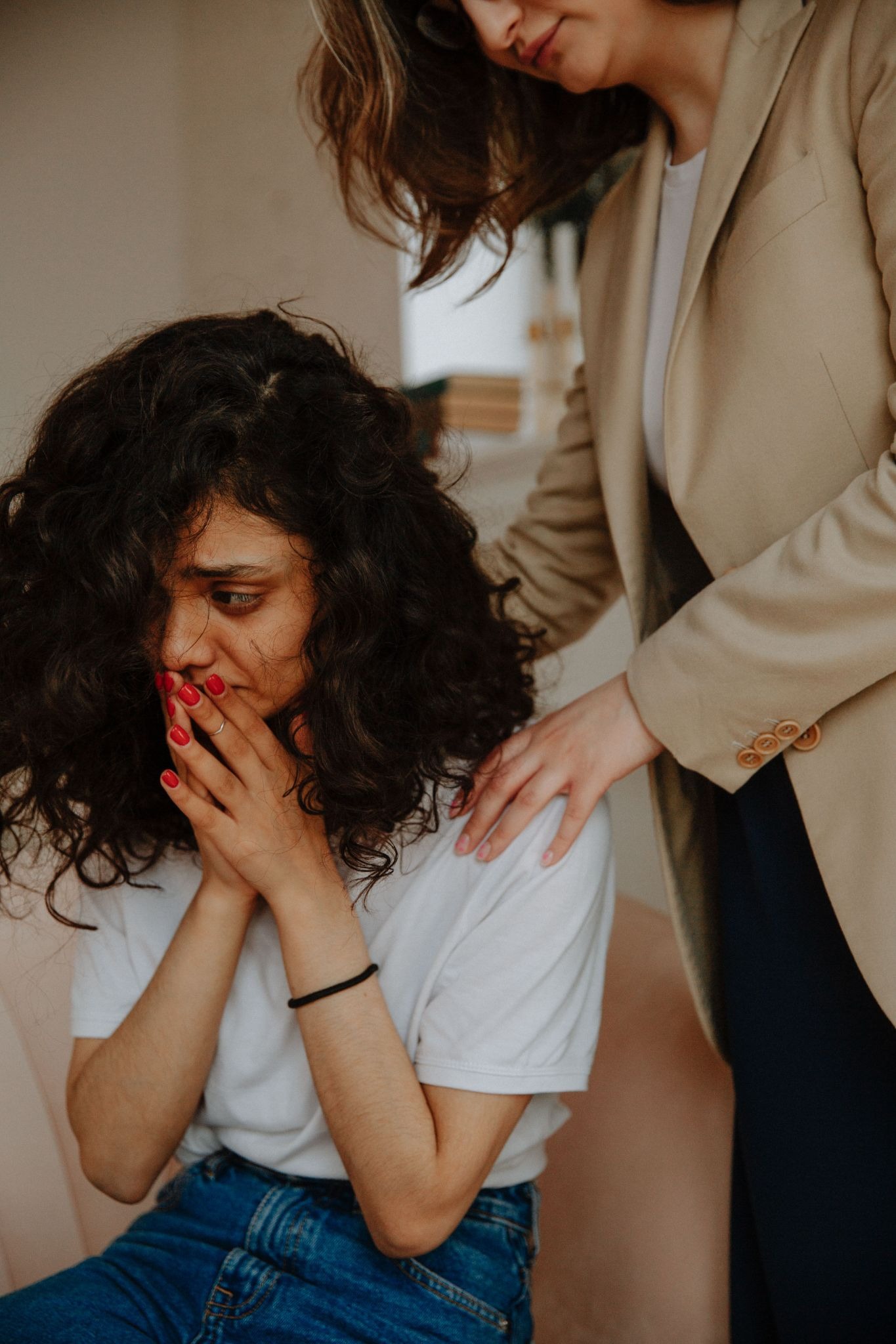 A compassionate clinician provides empathetic guidance to a client during a therapeutic session, illustrating the restorative power of mental wellness advocacy.