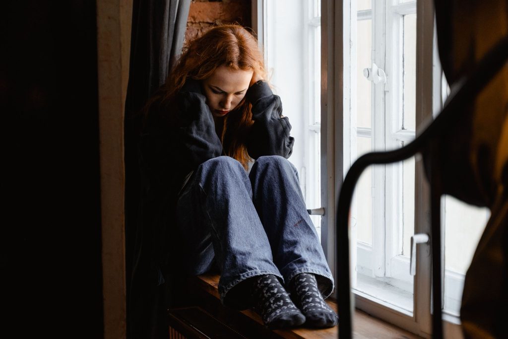 Teenager sitting quietly, showing common signs of anxiety in teens